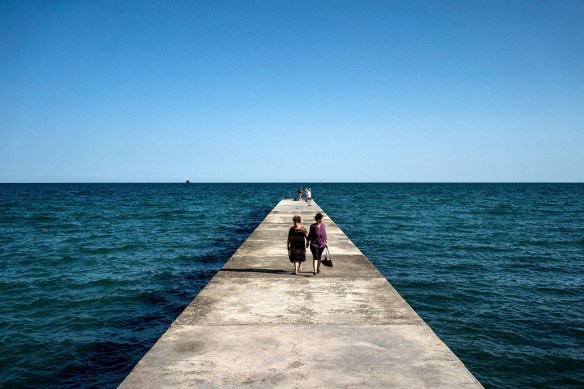 Tourists stroll on a pier in the Black Sea town of Balchik, Bulgaria, on August 25, 2017. # Dimitar Dilkoff : AFP : Getty